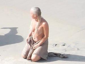 Strong naked woman with braided hair at beach Picture 4