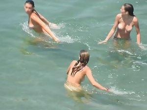 Teen nudist trio enjoying the water waves Picture 8