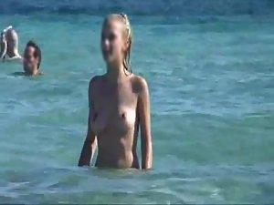 Thin topless woman smiles on a beach Picture 7
