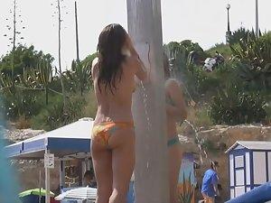 Naked woman with tattoos at beach shower Picture 5