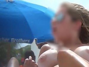 Young natural tits topless on beach Picture 1