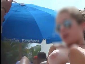 Young natural tits topless on beach Picture 3