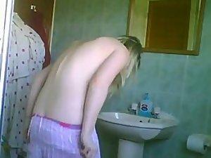 Blonde teenage girl in the bathroom