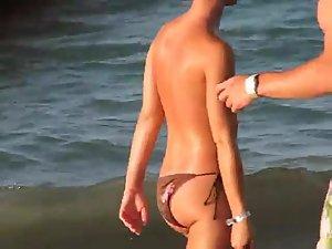 Sexy topless girl playing at the beach Picture 6