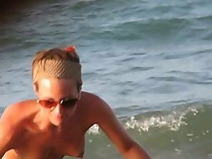 Sexy topless girl playing at the beach