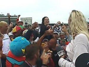 Happy lady flashes her tits to the crowd Picture 1