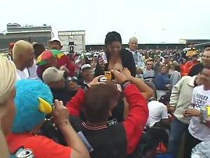 Happy lady flashes her tits to the crowd Picture 3