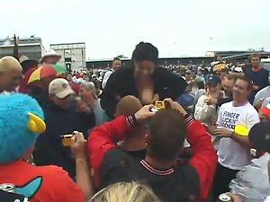 Happy lady flashes her tits to the crowd Picture 5