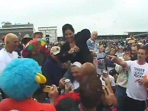 Happy lady flashes her tits to the crowd Picture 6