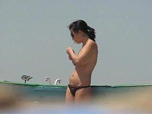 Topless babe lights a cigarette Picture 3