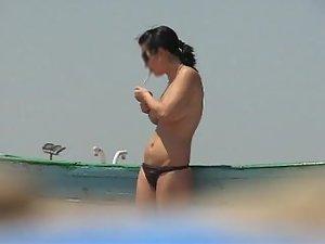 Topless babe lights a cigarette Picture 4