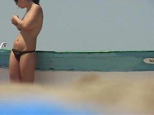 Topless babe lights a cigarette Picture 7