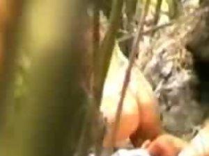 Voyeur watches love making in the woods