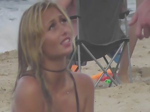 Silly blond girl gets dirty on beach