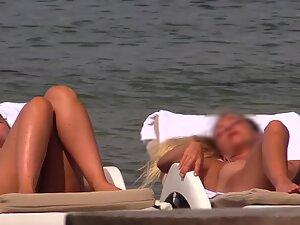 Voyeur checks out shy topless girls on beach Picture 1