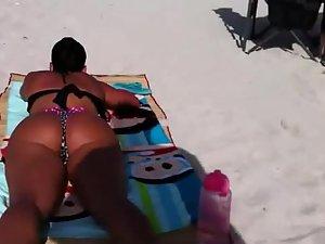 Dark tanned girl in a thong bikini Picture 6