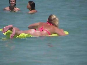 Pale buttocks in a pink thong bikini Picture 1