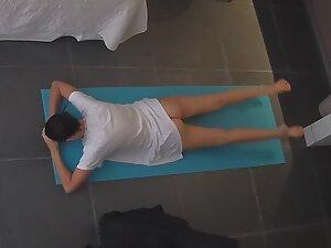 Peeping on woman doing half naked yoga exercises
