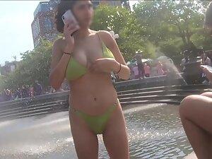 Busty girl shows off at the city fountain
