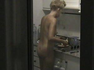 Peeping on a naked neighbor cooking Picture 2