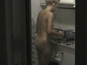 Peeping on a naked neighbor cooking Picture 3