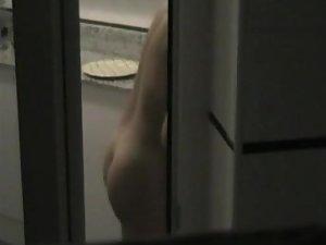 Peeping on a naked neighbor cooking Picture 7