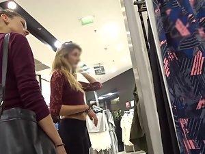 Slim blonde with messy hair is browsing the clothes store Picture 2