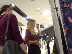 Slim blonde with messy hair is browsing the clothes store Picture 3