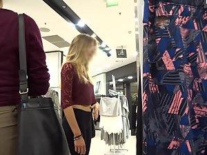 Slim blonde with messy hair is browsing the clothes store Picture 4