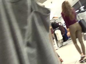 Slim blonde with messy hair is browsing the clothes store Picture 5