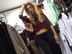 Slim blonde with messy hair is browsing the clothes store