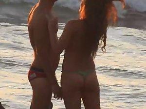 Topless redhead gets a hug