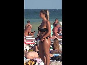 Voyeur zoom on hot cameltoe in black bikini Picture 2