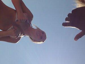 Funny girl shows her small tits to guys on beach Picture 4