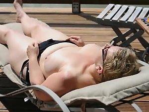 Wife spied as she relaxes in topless Picture 7
