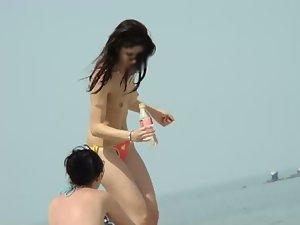 Topless babe steps out of the water Picture 7