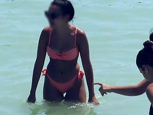 Ass in pink bikini is the highlight of the day on beach