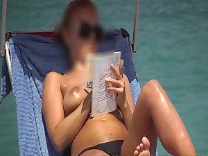 Spying a topless girl reading on a beach Picture 2