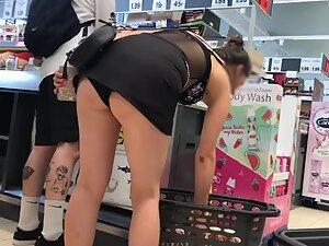 Bending over at cashier line exposes her upskirt
