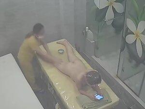 Naked woman is on her phone during entire massage Picture 1