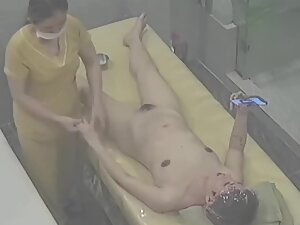 Naked woman is on her phone during entire massage