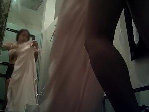 Spying on cute asian girl trying on dresses Picture 1