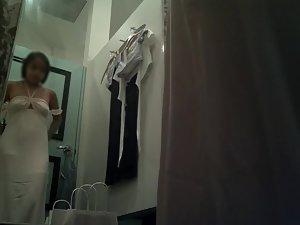 Spying on cute asian girl trying on dresses Picture 2
