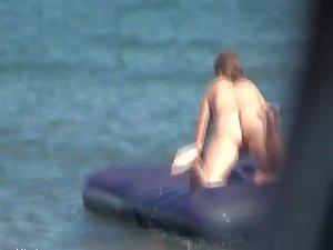 Hot girl on an air mattress at a beach Picture 7