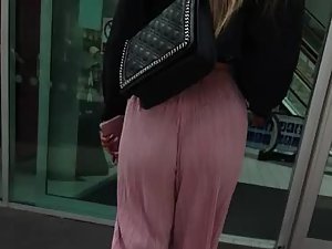 Loose pink pants wedged inside tight ass crack