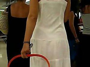 Thong peeks through her white dress