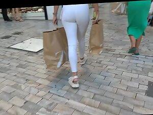 Voyeur notices a visible thong line under blonde's white pants Picture 3