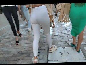 Voyeur notices a visible thong line under blonde's white pants Picture 8