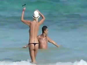 Skinny topless girl enters the water Picture 2