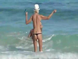 Skinny topless girl enters the water Picture 3